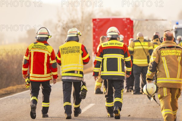 Fire team walking on the road, red vehicle protection in the background, fire department exercise on the Hermann Hesse Railway, Ostelsheim, Calw district, Germany