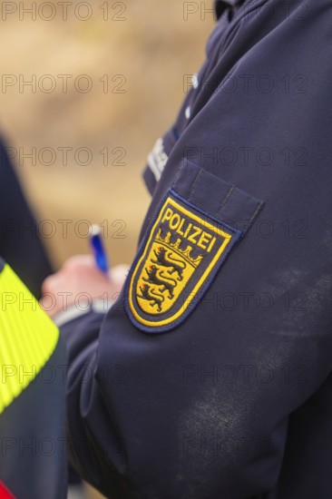 Close-up of a police badge on a blue uniform with lettering and logo, fire department exercise at the Hermann Hesse Railway, Ostelsheim, Calw district, Germany