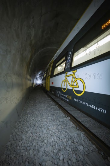 Train with bicycle graphics on the side passes through a tunnel, fire department exercise on the Hermann Hesse railway, Ostelsheim, Germany