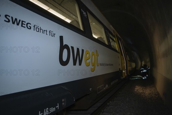 Train in a tunnel with lettering on the side in dark surroundings, fire department exercise on the Hermann Hesse railway, Ostelsheim, Germany