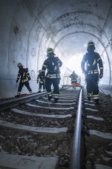Firefighters in a tunnel on rails during an operation, fire brigade exercise on the Hermann Hesse railway, Ostelsheim, Germany