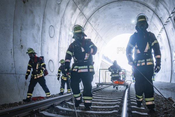 Firefighters in a tunnel working on rails, fire brigade exercise on the Hermann Hesse Railway, Ostelsheim, Germany