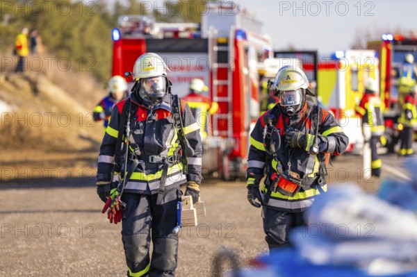 Two firefighters with respirators and full equipment on duty, fire brigade exercise on the Hermann Hesse railway, Ostelsheim, Germany