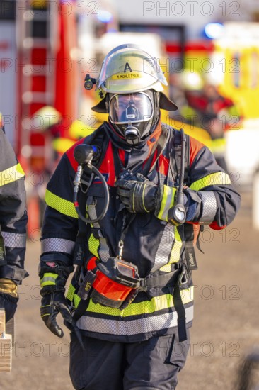Firefighter wearing full protective clothing during an operation, fire brigade exercise on the Hermann Hesse railway, Ostelsheim, Germany