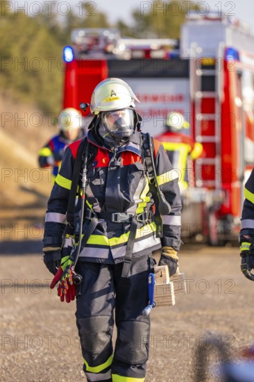 Firefighter wearing respirator and equipment during an operation, fire brigade exercise on the Hermann Hesse railway, Ostelsheim, Germany