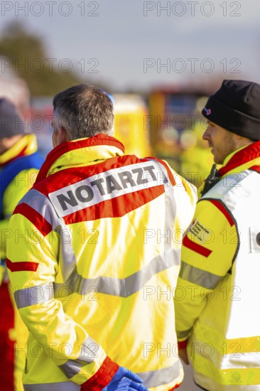 Rescue team wearing operational clothing in an emergency situation on a road, fire brigade exercise on the Hermann Hesse railway, Ostelsheim, Germany