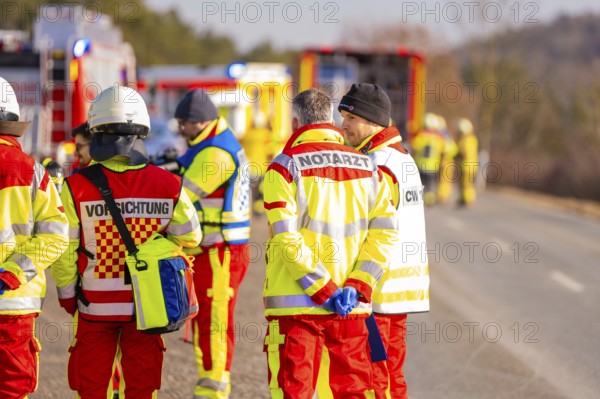 Group of rescue workers and firefighters on a street during an emergency operation, fire brigade exercise on the Hermann Hesse railway, Ostelsheim, Germany