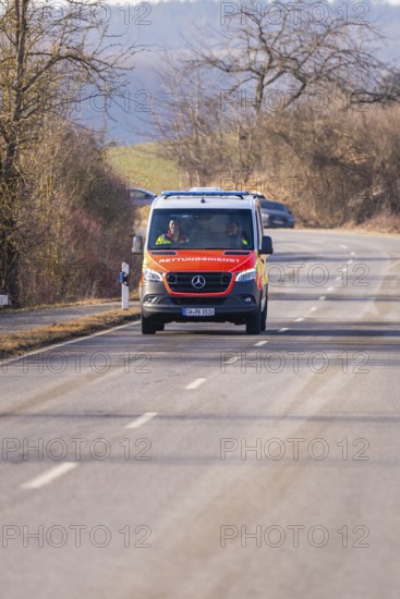 An ambulance drives along a winding country road, fire department exercise on the Hermann Hesse railway, Ostelsheim, Germany