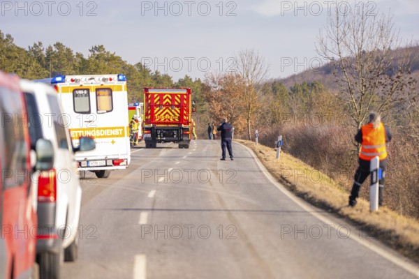 Street scene with emergency vehicles and personnel in a wintry landscape, fire brigade exercise on the Hermann Hesse railway, Ostelsheim, Germany