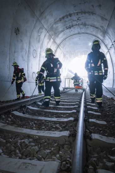 Firefighters on train tracks in a tunnel during an operation, fire brigade exercise on the Hermann Hesse railway, Ostelsheim, Germany