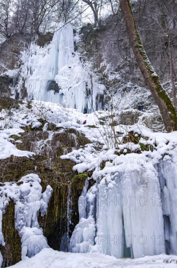 Urach waterfall full of bizarre ice formations frozen at winter temperatures, Bad Urach, Swabian Jura, Baden-Württemberg, Germany