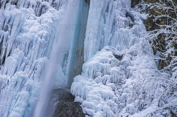 Urach waterfall full of bizarre ice formations frozen at winter temperatures, Bad Urach, Swabian Jura, Baden-Württemberg, Germany