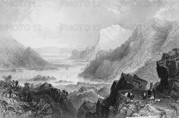Arrival in Killarney on Lough Leane by way from Kenmare, County Kerry, Ireland, wild mountain scenery, lake, small island, quiet atmosphere, hiker, break, dog, steep rock face, natural landscape, rocks, landmark, steel engraving, 19th century, historical illustration from 1845