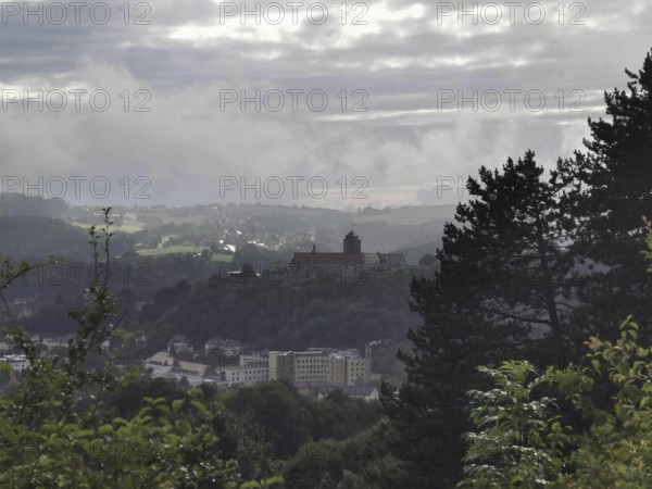 Fortress on a hill in fog with a view of a wide landscape, view over Kronach, Frankenwald nature park Park