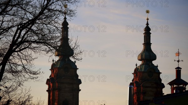 Church towers at sunset as silhouettes against a pastel-coloured sky, Franconian Forest nature park Park