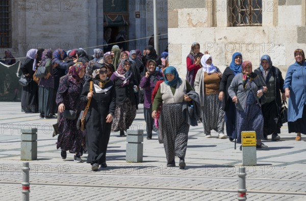 Group of woman in traditional Islamic dress in a square, woman after prayer at Konya Sultan Selim Camii, Konya, Central Anatolia, Turkey