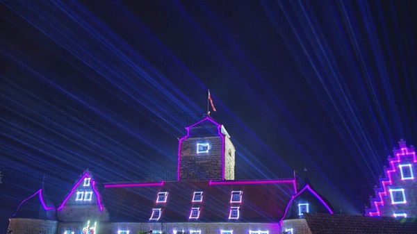 Impressive laser light show over a castle at night, Kronach glows, Frankenwald nature park Park