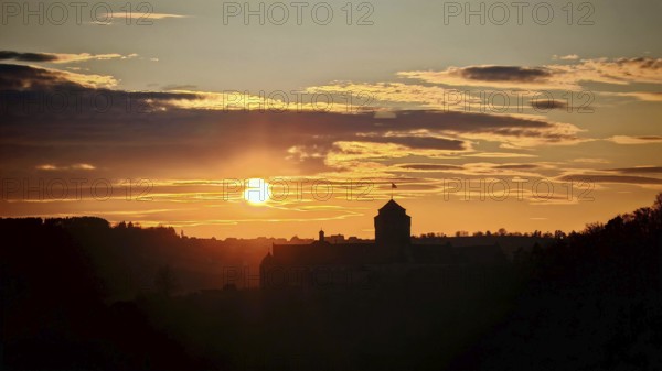 Sunset behind a castle, the silhouette is visible in the sky, view of Rosenberg Fortress, Kronach, Frankenwald nature park Park