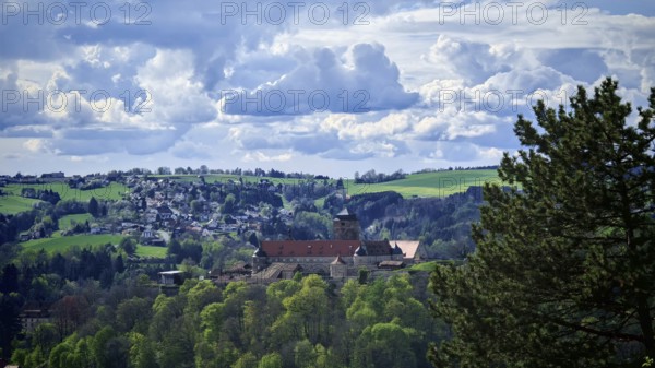 View of a castle surrounded by green hills and dramatic clouds, view of Rosenberg Fortress, Kronach, Frankenwald nature park Park