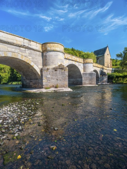 13th century medieval stone bridge across the Werra river, in the back the Liborius chapel, Creuzburg, Thuringia, Germany