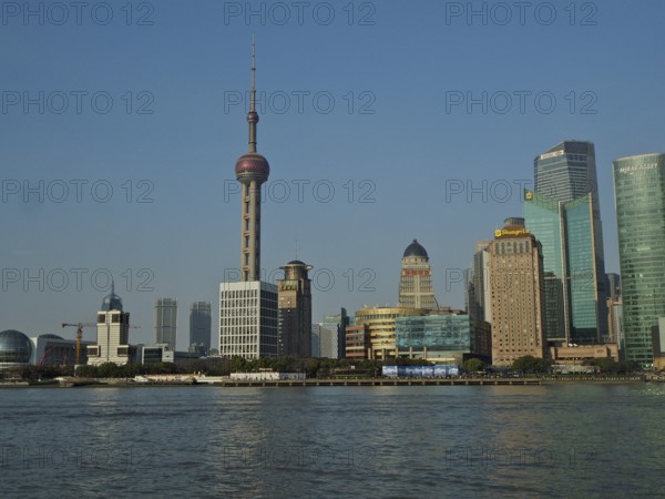 Panorama of a modern skyline of Huangpu Jiang with television tower and water in the foreground, Pudong, Shanghai, China