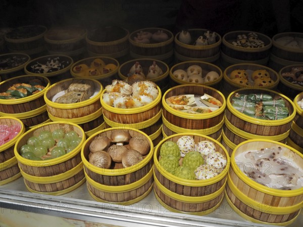 Different types of dim sum carefully arranged in bamboo steamers at a wet market, French Concession, Shanghai, China