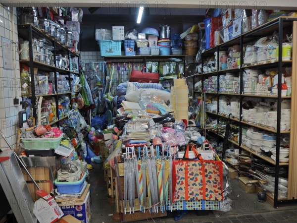 Small shop with a variety of everyday items on densely packed shelves and tables, Wet Market, French Concession, Shanghai, China