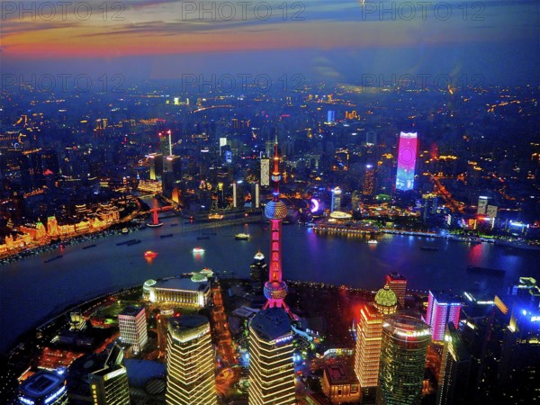 Colorful skyline lights at sunset with river in the foreground, Shanghai, China
