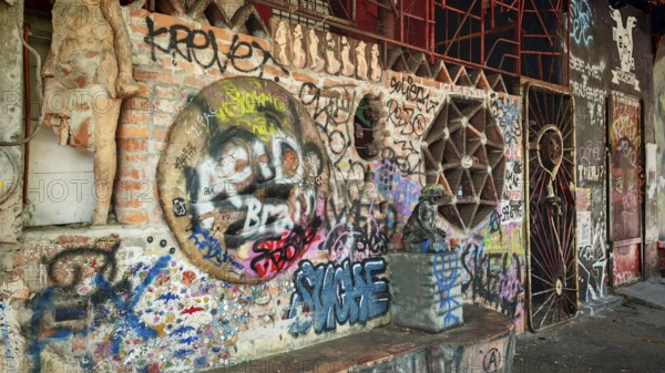 Different graffiti on a brick wall in an urban environment with a mix of cultures, Ljubljana, Slovenia