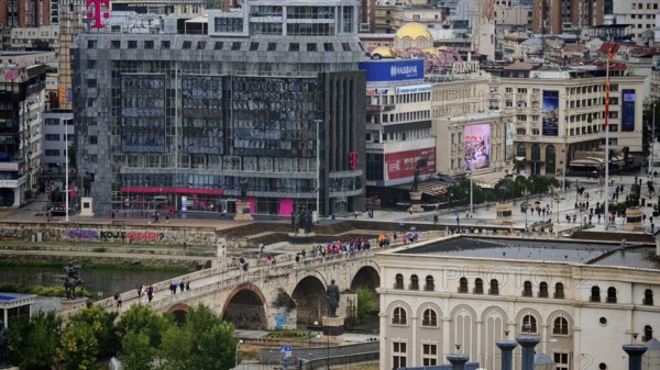 View of a city with a modern building and a bridge, Skopje, North Macedonia