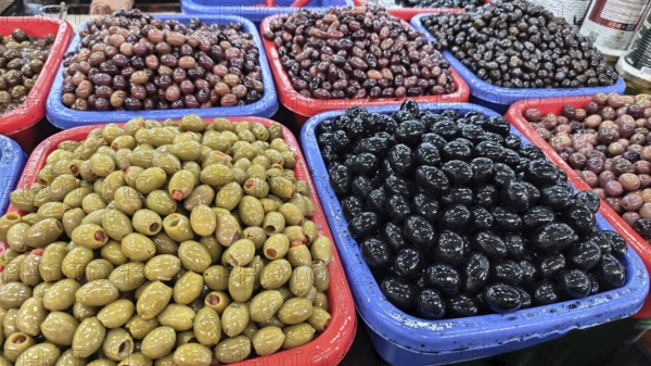 Colourful containers with different types of olives (olivae) at a market, Skopje, North Macedonia
