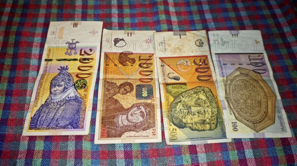 Different denarius banknotes from North Macedonia on a colorful tablecloth, Skopje, North Macedonia