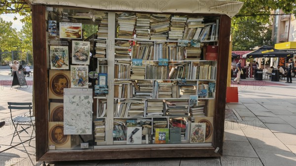 A bookstand with numerous books and posters in an urban square, Pristina, Kosovo