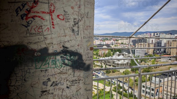 Wall with graffiti and cityscape in the background, Pristina, Kosovo