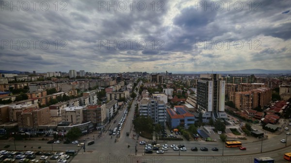 City panorama with dramatic cloudy sky and buildings, Pristina, Kosovo