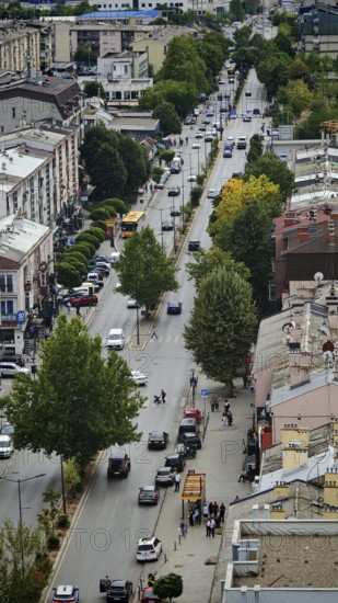 Aerial view of busy urban street with trees and vehicles, Pristina, Kosovo