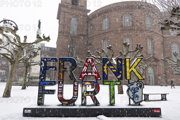 A passerby walks past St. Paul's Church in Frankfurt with an umbrella. Heavy snowfalls have caused another onset of winter in the Main metropolis, Osthafen, Frankfurt am Main, Hesse, Germany
