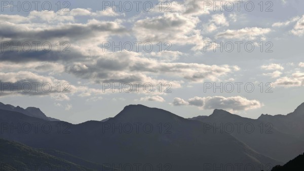 Mountain ranges in the background with clouds in the sky and a calm atmosphere, Peaks of the Balkans, Plav Lake, Montenegro