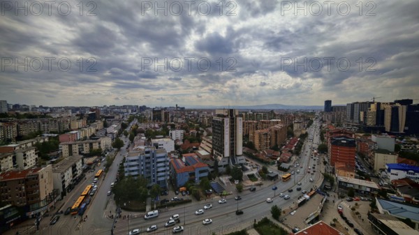 City view with busy streets, buildings and cloudy sky, Pristina, Kosovo