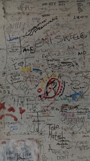 Colourful graffiti and doodles cover a wall, Pristina, Kosovo