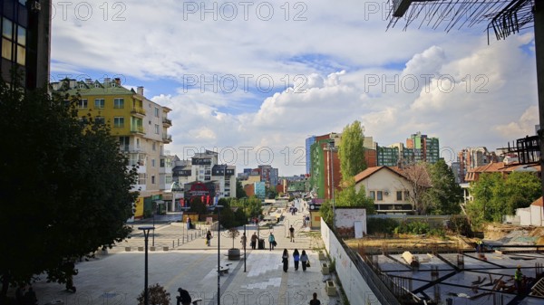 City view with modern buildings, under a cloudy sky, Pristina, Kosovo