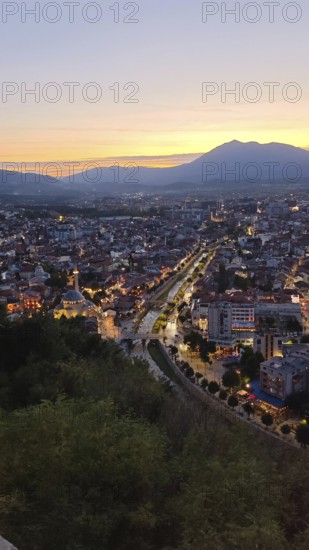 Evening panoramic view of the city with illuminated streets and river, Prizren, Kosovo