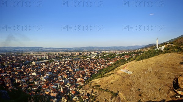 Wide view of a city and surrounding hills under blue sky, Prizren, Kosovo