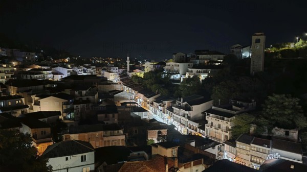 Night view of illuminated cityscape with houses and roads in darkness, Montenegro