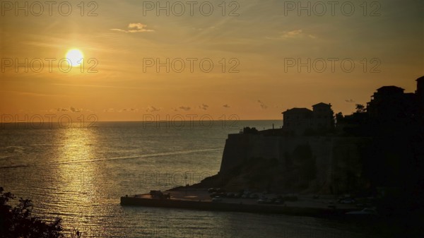 Sunset over ocean with golden colors and silhouettes, Ulcinj, Montenegro