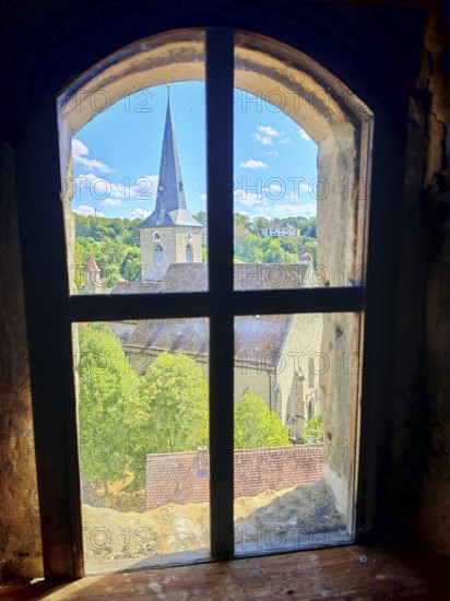 View from a rustic window of a village with a church under a clear summer sky, Upper Franconia