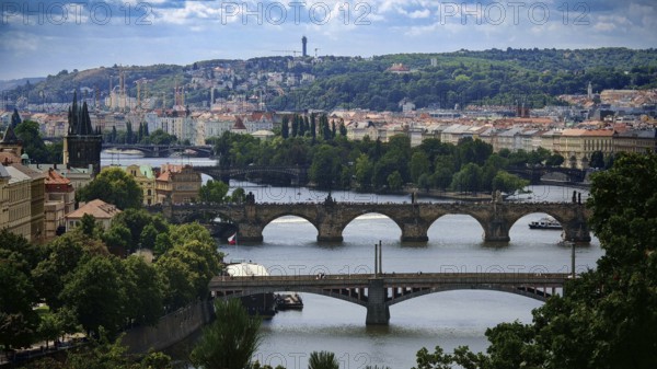 View of river and several bridges surrounded by urban architecture and hills, view of Charles Bridge, Prague, Czech Republic