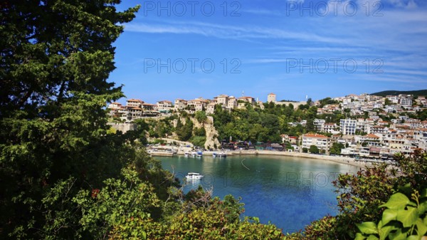 Panoramic view of a coastal town with boats and hills surrounded by clear skies, view of Ulcinj, Montenegro