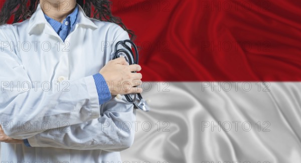 Healthcare professional with Monaco flag background. Professional doctor holding stethoscope on Monaco flag background