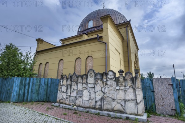 Destroyed synagogue under reconstruction, in front a wall of remembrance, constructed fragments of destroyed tombstones, Jewish cemetery, since 1866, Czernowicz, Ukraine